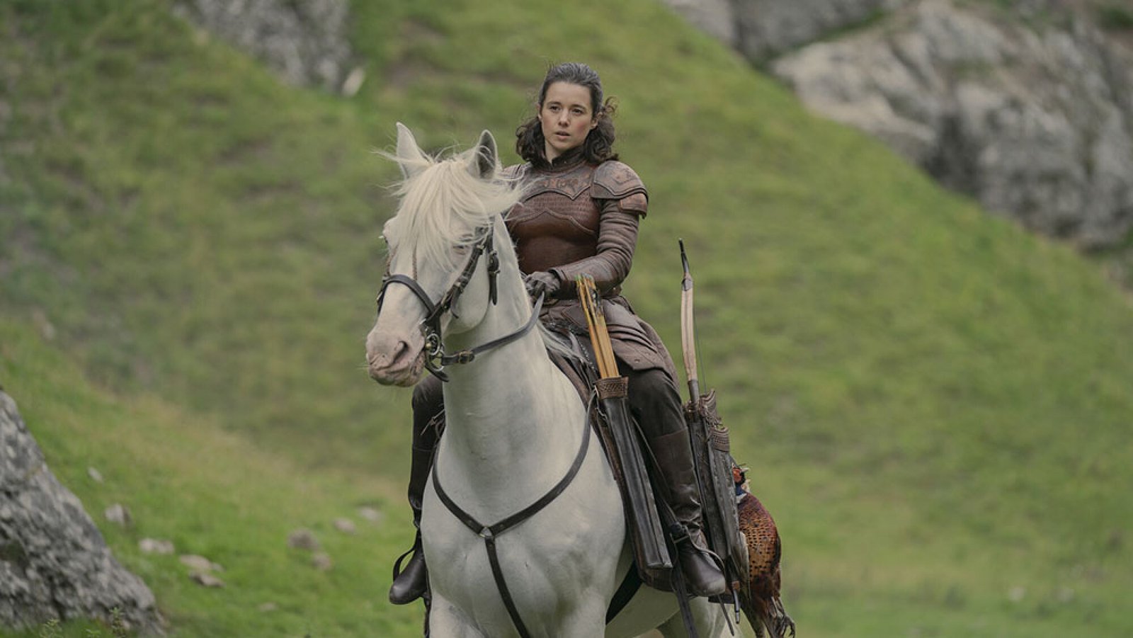 images-8-fill_-size_2000x1126-v1715267481 A woman in medieval clothing rides a white horse outdoors.
